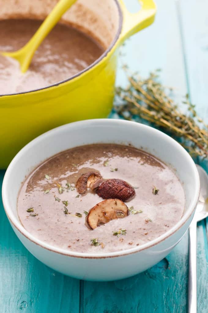 Milestones' Roasted Mushroom Soup in white bowl on blue table