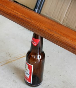 Wooden railing on beer bottle