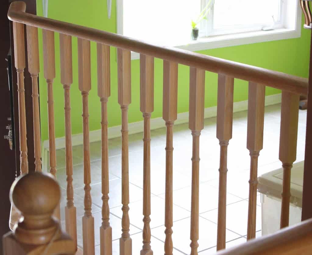 Wooden railings, green wall, floor and window in the background