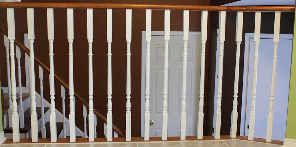 Wooden white and brown railings, white doors in the background