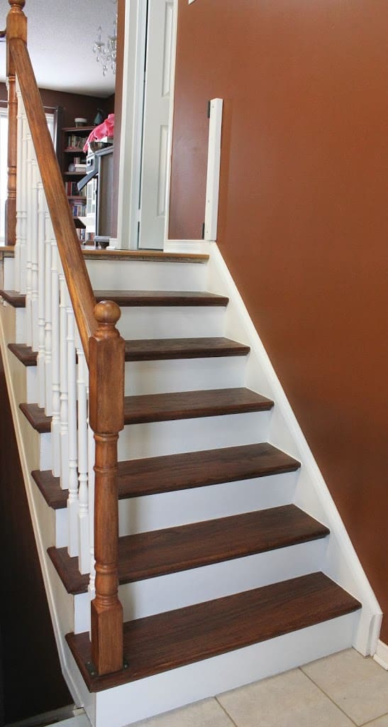 Brown and white stairway with railing