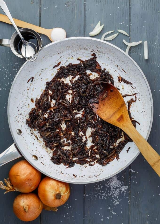 How to Caramelize Onions - caramelized onion in pan with wooden spatula top view