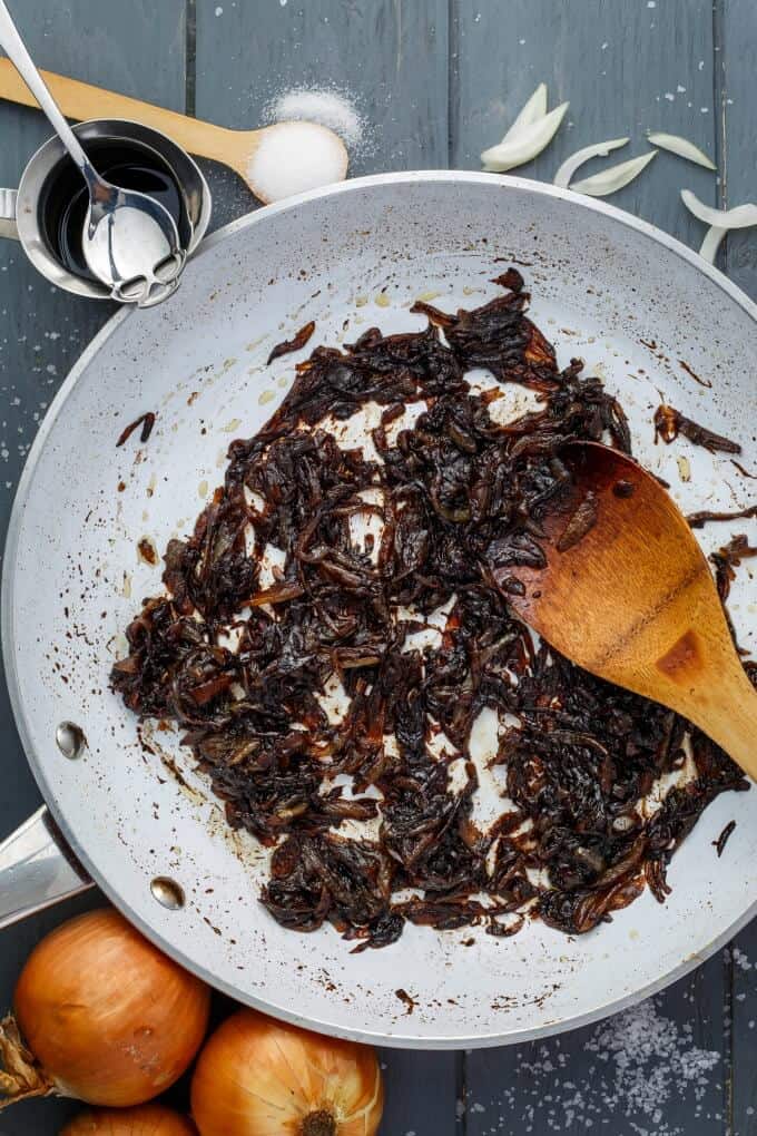 How to Caramelize Onions - caramelized onion in pan with wooden patula