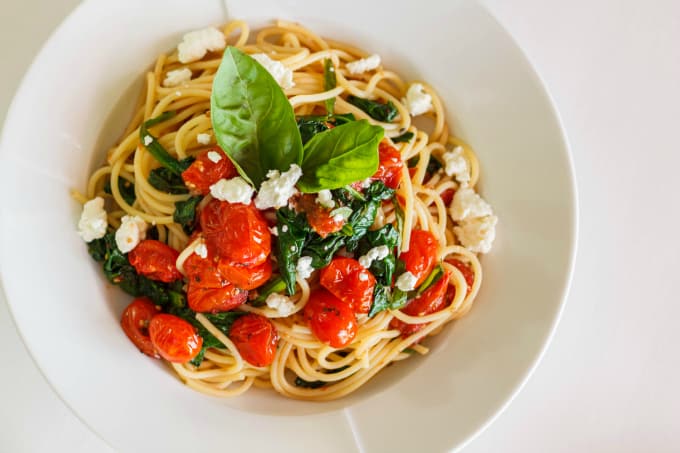 Milestones Tomato Basil Brown Rice Spaghettini on white plate, on white background, top view