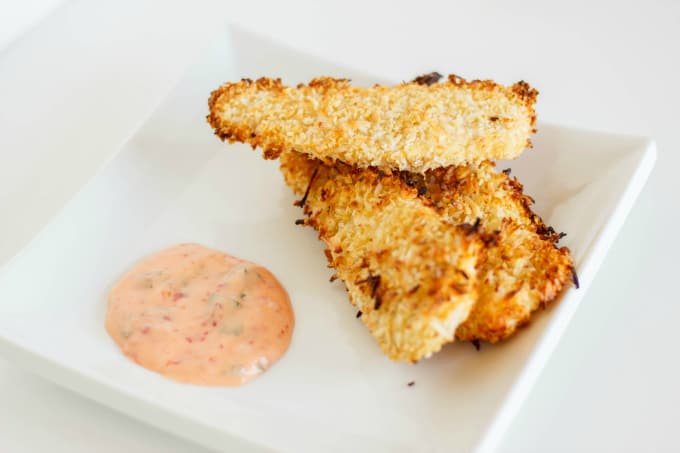 Coconut Breaded Chicken with Chili Garlic Dipping Sauce on white plate, white background