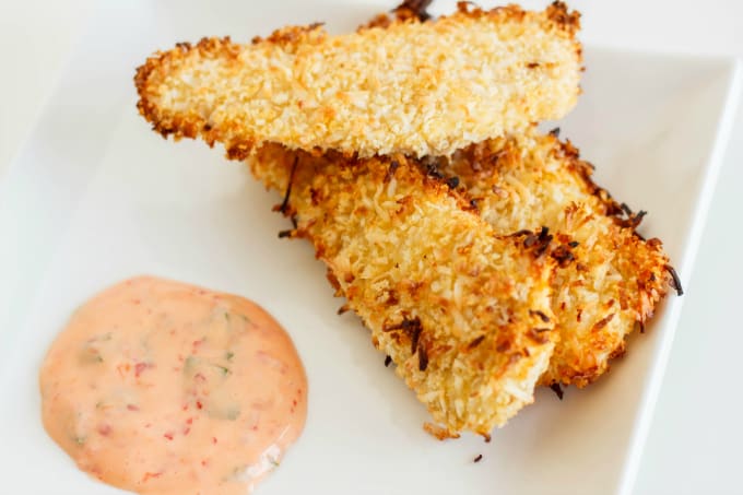 Coconut Breaded Chicken with Chili Garlic Dipping Sauce on white plate, white background