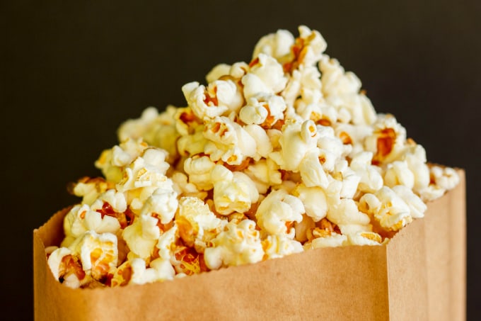 Healthy Stove Top Popcorn  in paper bag on black background