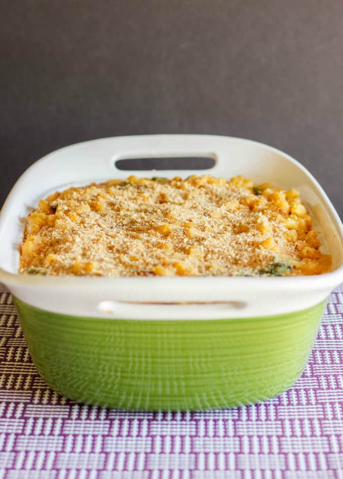 Macaroni and Cheese with Sun-dried Tomatoes and Spinach in big bowl on purple white table cloth