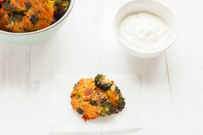 Broccoli Bite Burger on white table near bowls with  dip and burgers