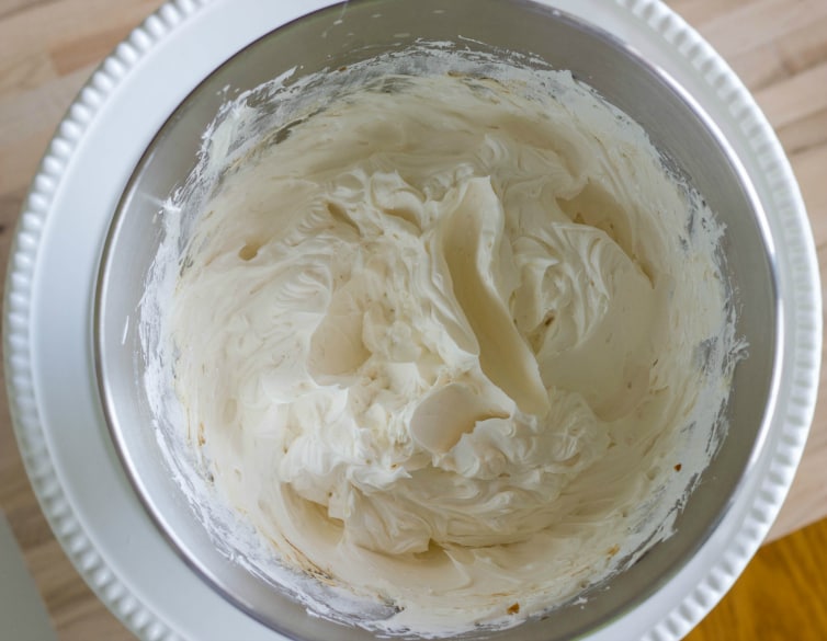 White meringue buttercream in bowl on table