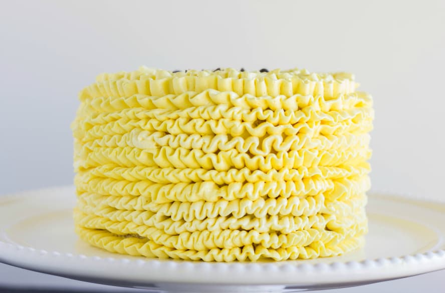 Yellow cake on stray, white background