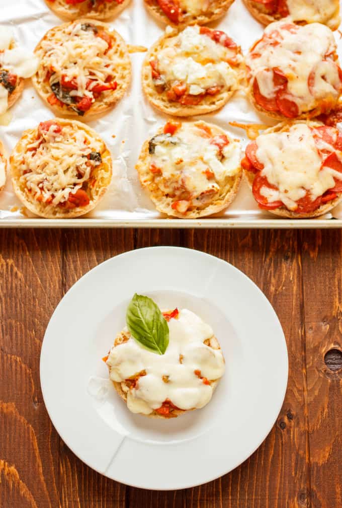 Mini Pizzas on English Muffins next to mini pizza on english muffin on white plate