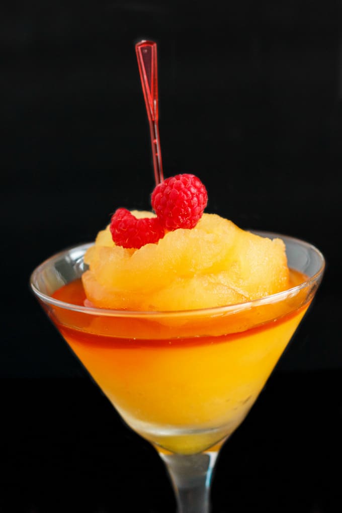 Milestones Bellini in glass cp with berries and red pick