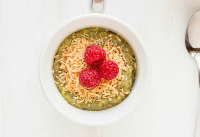 Vegan Green Tea Chia Seed Pudding in white bowl with raspberries