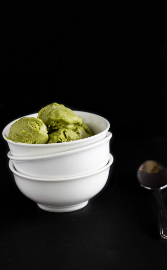 Vegan tea icea cream in white bowl, black background