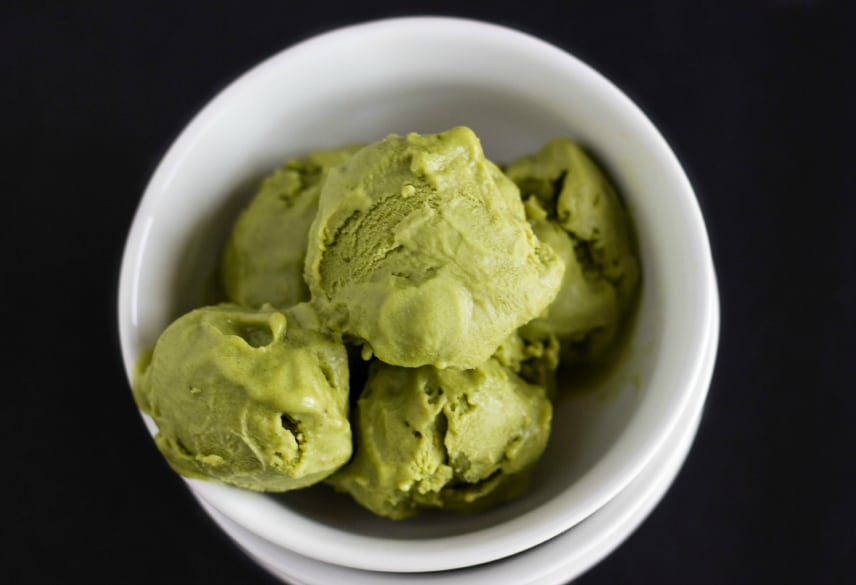 Vegan green tea ice cream in white bowl on black background