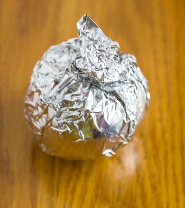 Baked Campfire Apple in baking foil on brown table
