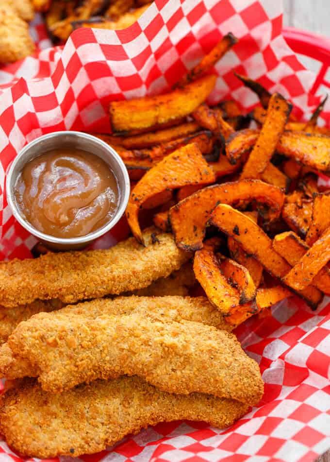 Butternut Squash Fries  with fried dish and dip in small bowl on red white paper sheet