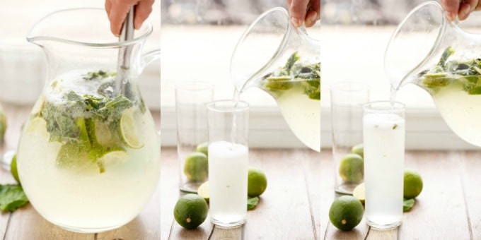 Half Pitcher of Mojitos being poured in glass with chopped lemons#pour