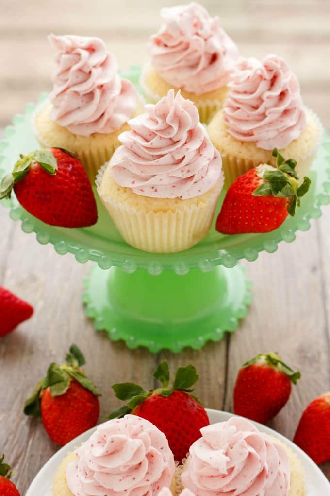 Lemon Cupcakes with Strawberry Swiss Meringue Buttercream  on green stray on brown table with ripe strawberries#dessert