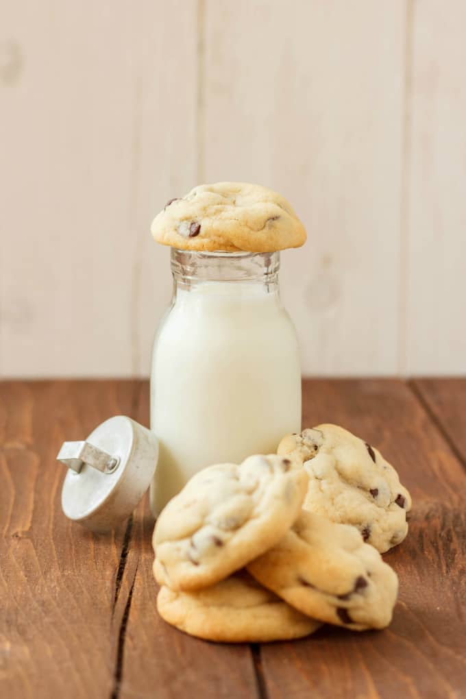 Pillsbury Cookbook 1989 Chocolate Chip Cookies on wiiden table with glass jar of milk with lid