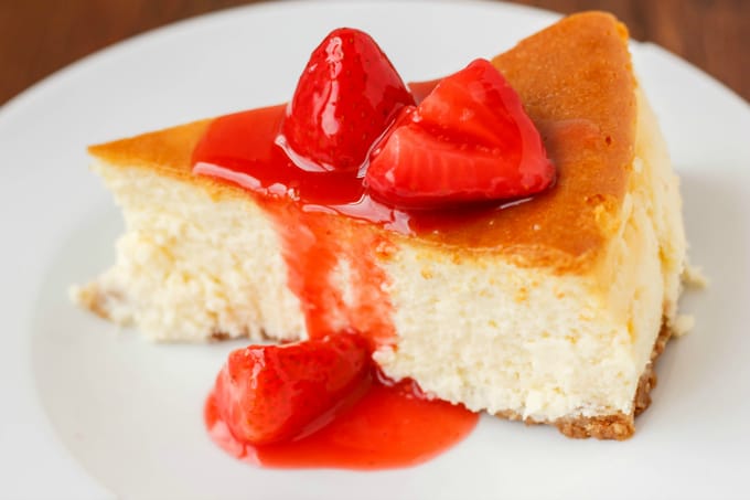 New York Style Cheesecake with Strawberry Topping on white plate