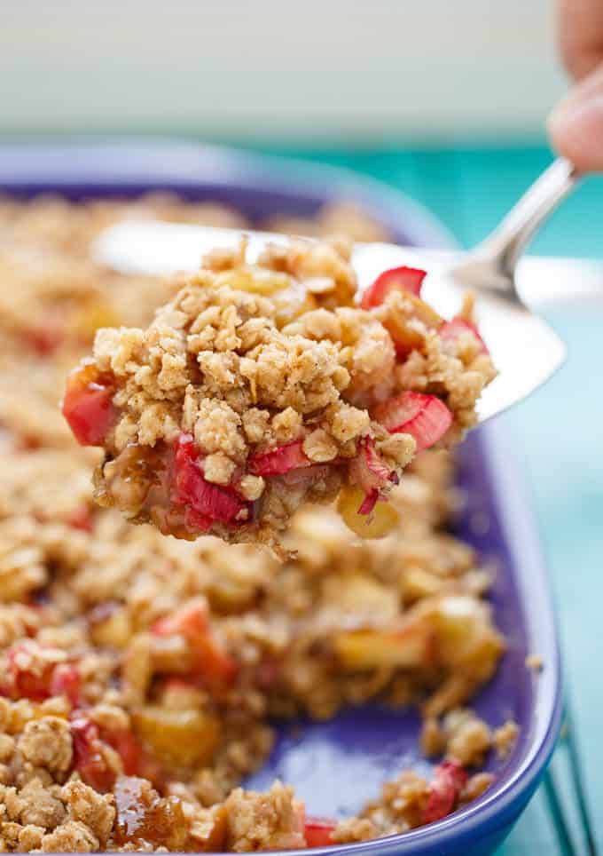 Rhubarb Crumble Brown Betty dessert on spatula over baking purple pan on blue table#dessert