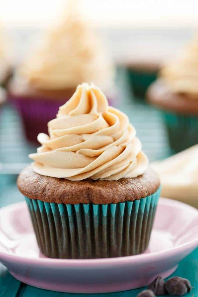 Gluten-Free Chocolate Cupcakes with Peanut Butter Frosting  on pink plate on blue table#cupcakes