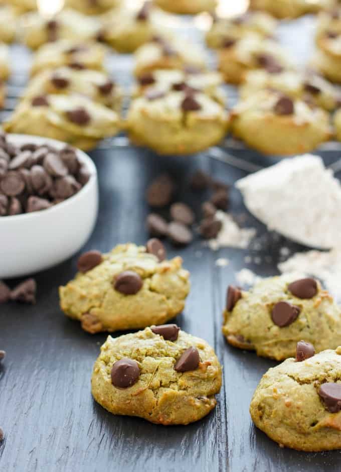 Avocado Chocolate Chip Cookies on black table with chocolate chips in bowl and flour in spoon#cookies
