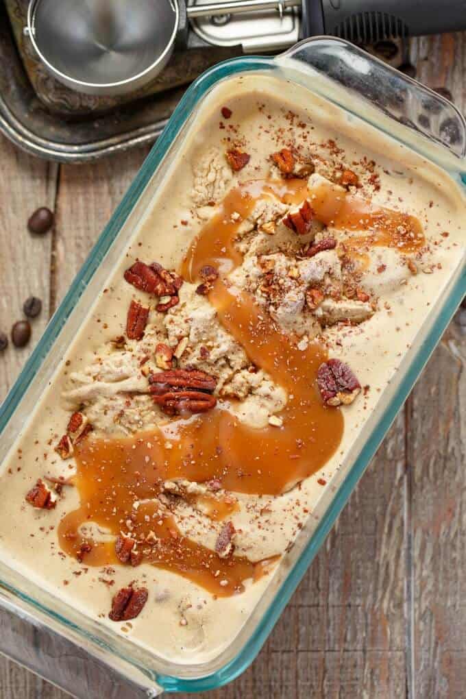 Coffee Ice Cream with Toasted Pecans and a Caramel Swirl  in glass container on wooden table#icecream