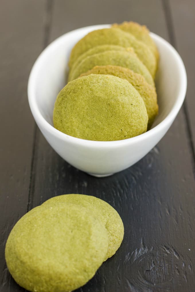 Matcha Green Tea Shortbread Cookies in white bowl and on black table