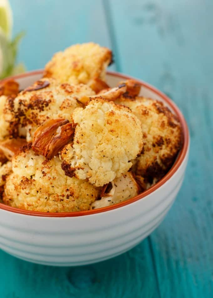 Roasted Cauliflower with Garlic  in white bowl on blue table#roasted #cauliflower