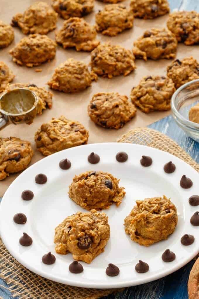 Sweet Potato Chocolate Chip Cookies on white plate and cookies on sheet of baking paper