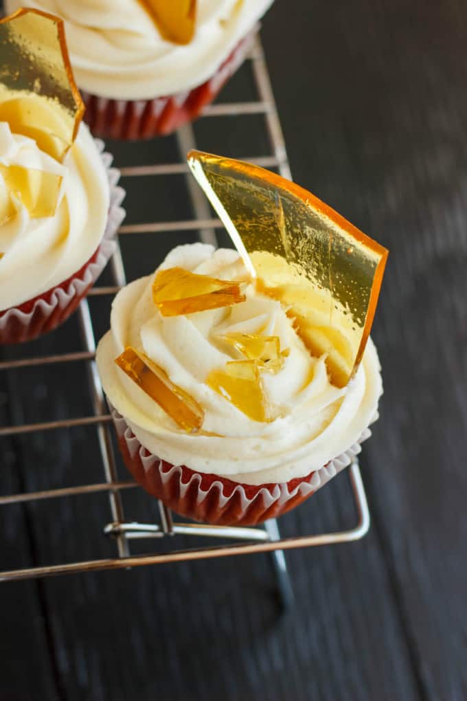 Halloween Cupcakes Blood Cupcakes with Broken Beer Bottle Glass Shards on baking rack on black table