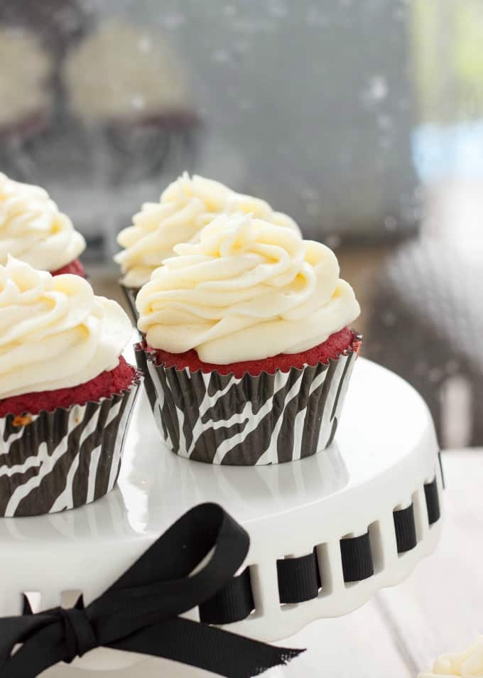 Red Velvet Cupcakes with Cream Cheese Frosting on white tray with black tie #cupcakes