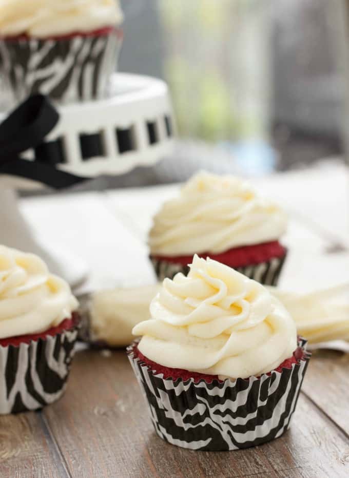 Red Velvet Cupcakes with Cream Cheese Frosting on brown table #dessert