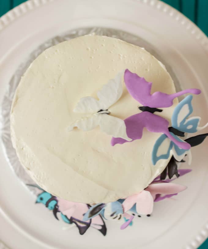 Pink Ombre Cake with Royal Icing Butterflies on white tray top view