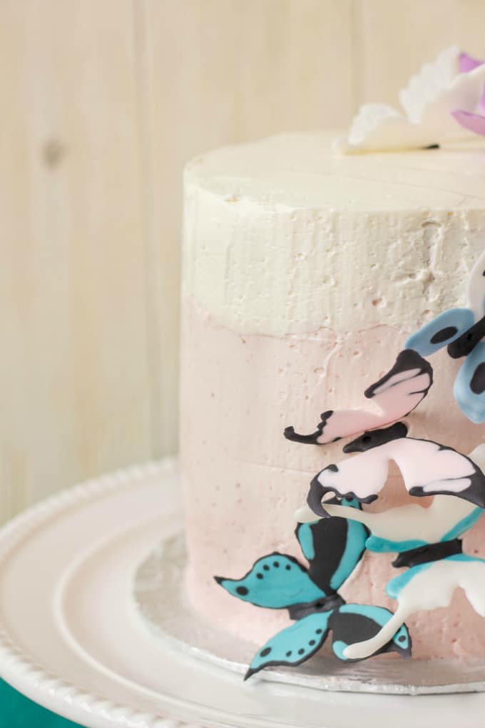 Pink Ombre Cake with Royal Icing Butterflies on white tray on white background