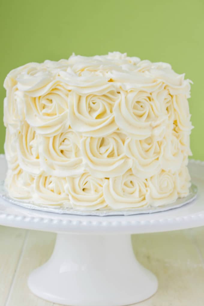 Red Velvet Cake with Vanilla Buttercream Rosettes on white tray on white table