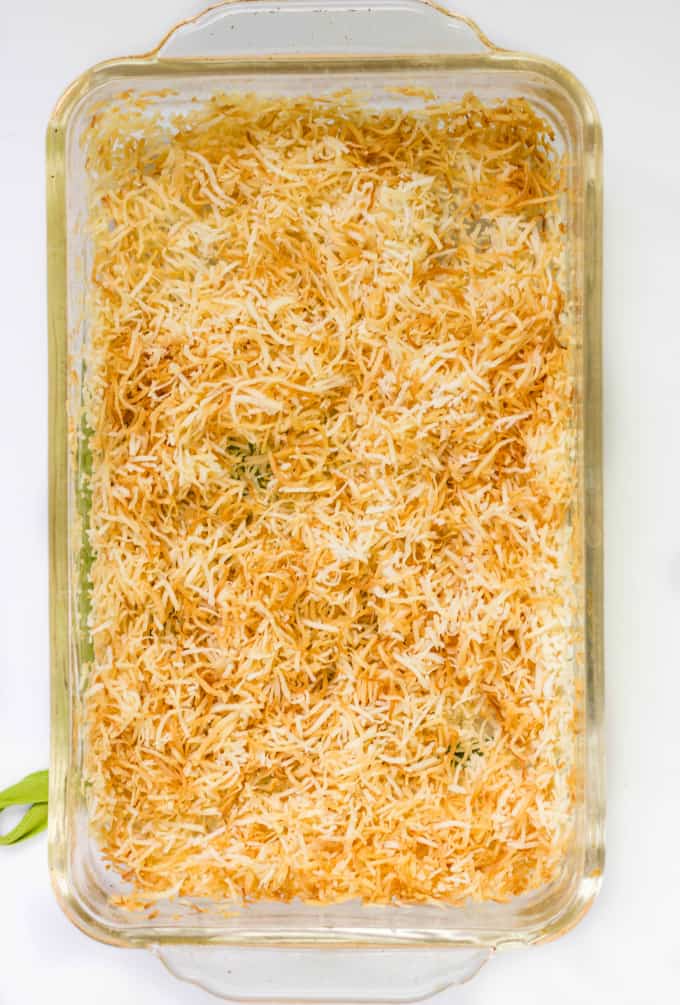 Toasted Coconut and normal coconut sliced in glass container on white table