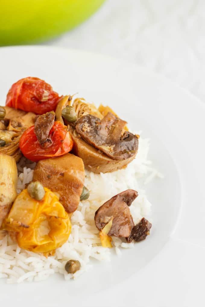 Artichoke Hearts and Mushrooms over Rice on white plate