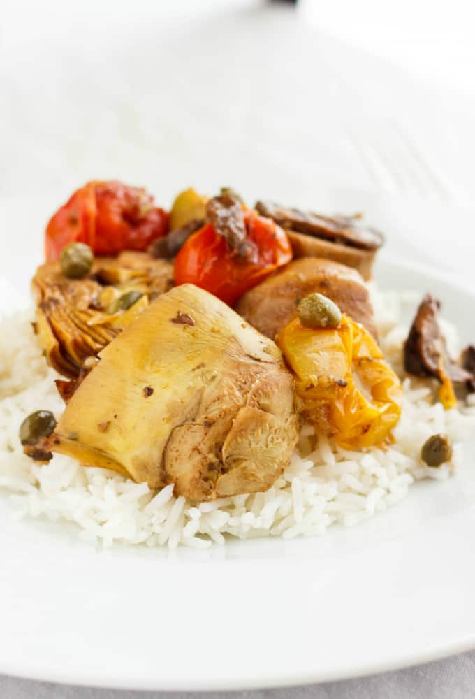 Artichoke Hearts and Mushrooms over Rice on white plate