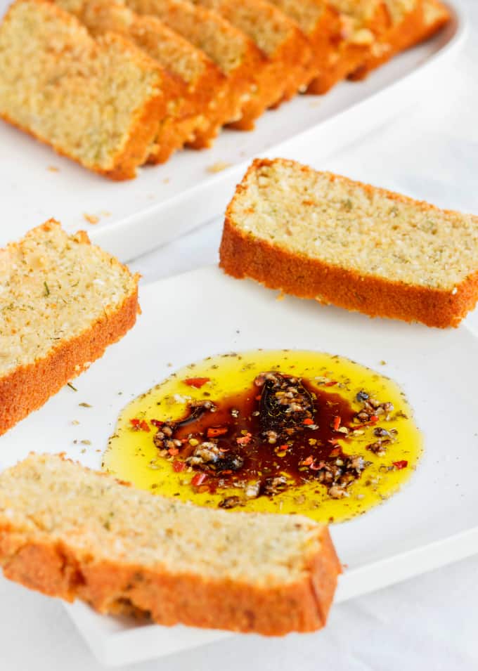 Beer and Parmesan Bread slices made with Lentil Flour on white plates with sauce