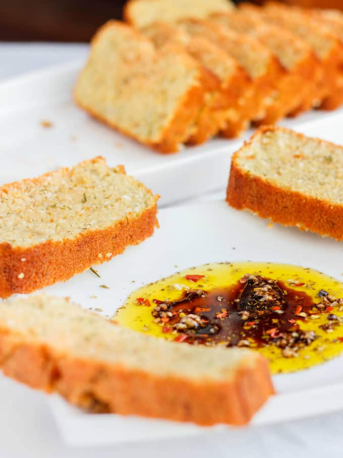 Beer and Parmesan Bread slices made with Lentil Flouron on white plates with sauce