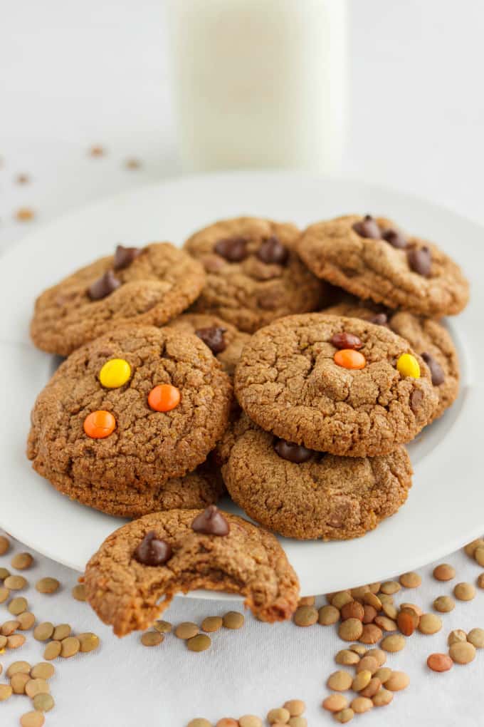 Chocolate Chip Cookies made with Lentil Flour on white plate on white table poured by lentils