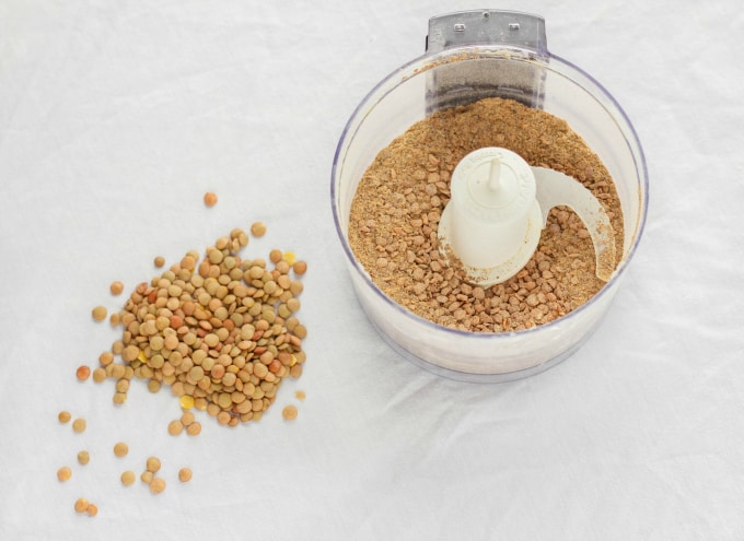 Lentils in blender and lentils on white table