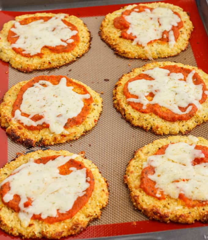 Mini Cauliflower and Quinoa Crust Pizzas on red brown pad