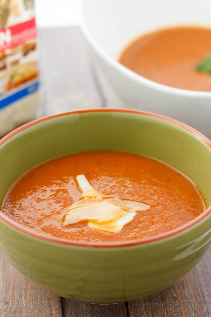 Roasted garlic tomato soup in green bowl