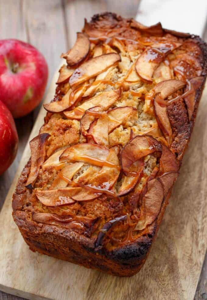 Apple Cinnamon Bread with Caramel on wooden pad with red apples