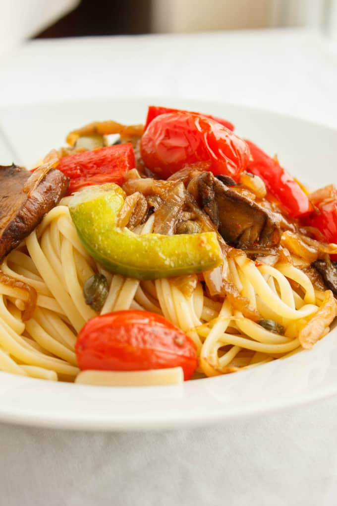 Artichoke Hearts, Caramelized Onions and Roasted Portobello Mushroom Pasta on white plate, close view